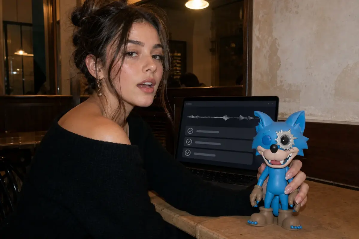 Young creator holding a blue hard-shell WOWNNY collectible beside a voice summary and action checklist