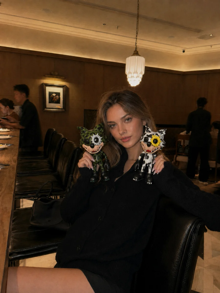 Creator carrying a smooth hard-shell WOWNNY collectible in a restaurant