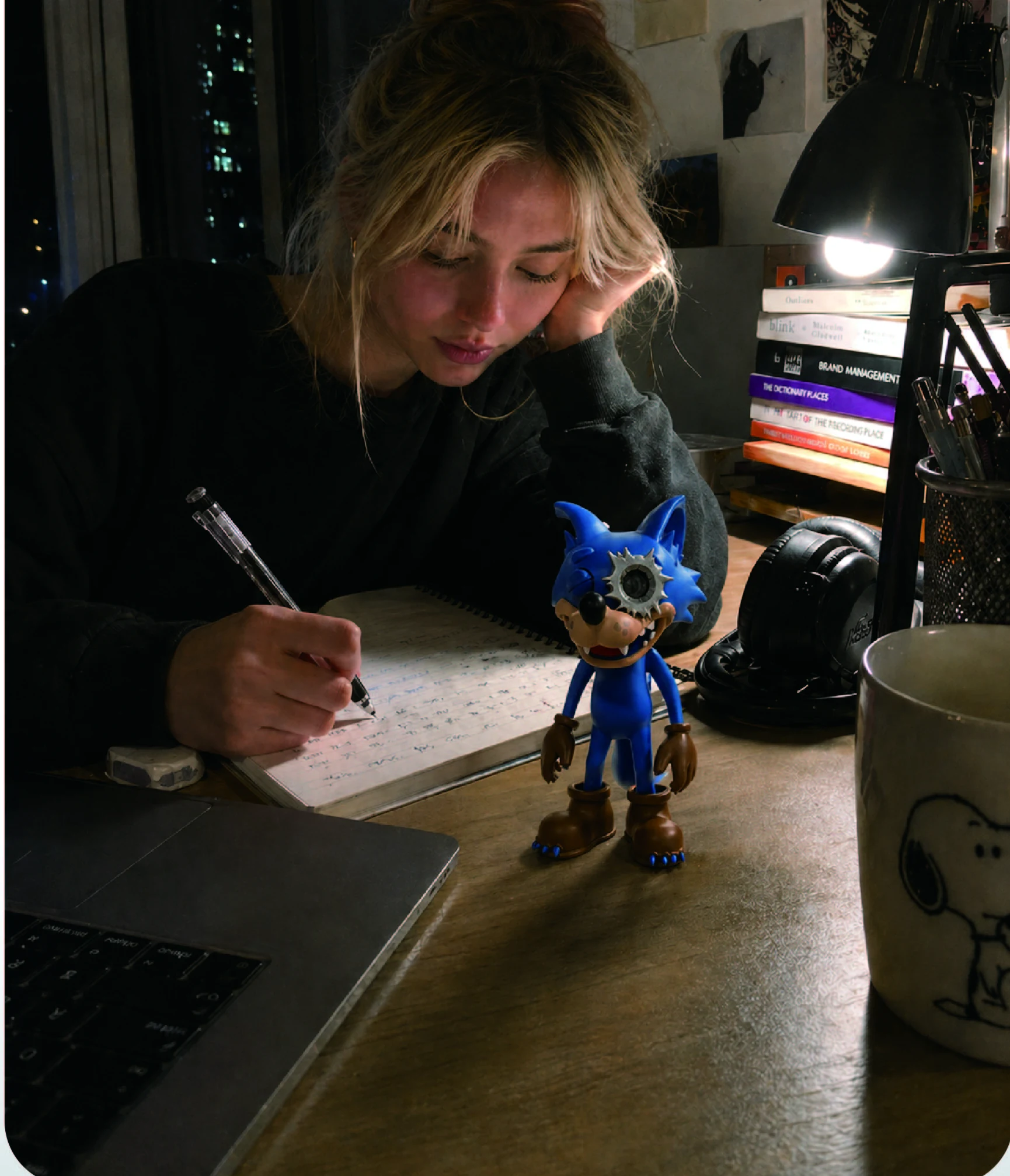WOWNNY blue companion on a desk while a creator writes notes